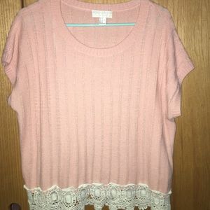 A baby pink quilted blouse.